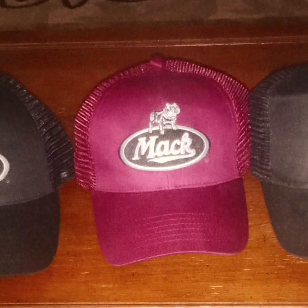 Lot of three Mack trucker hats one maroon two black one size fits off.